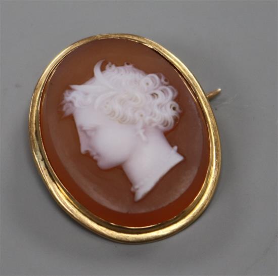 A yellow metal mounted hardstone oval cameo brooch, carved with head of a lady to dexter, 29mm.